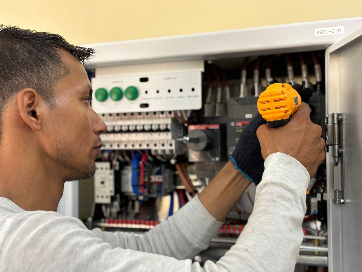Technician inspecting an electrical panel