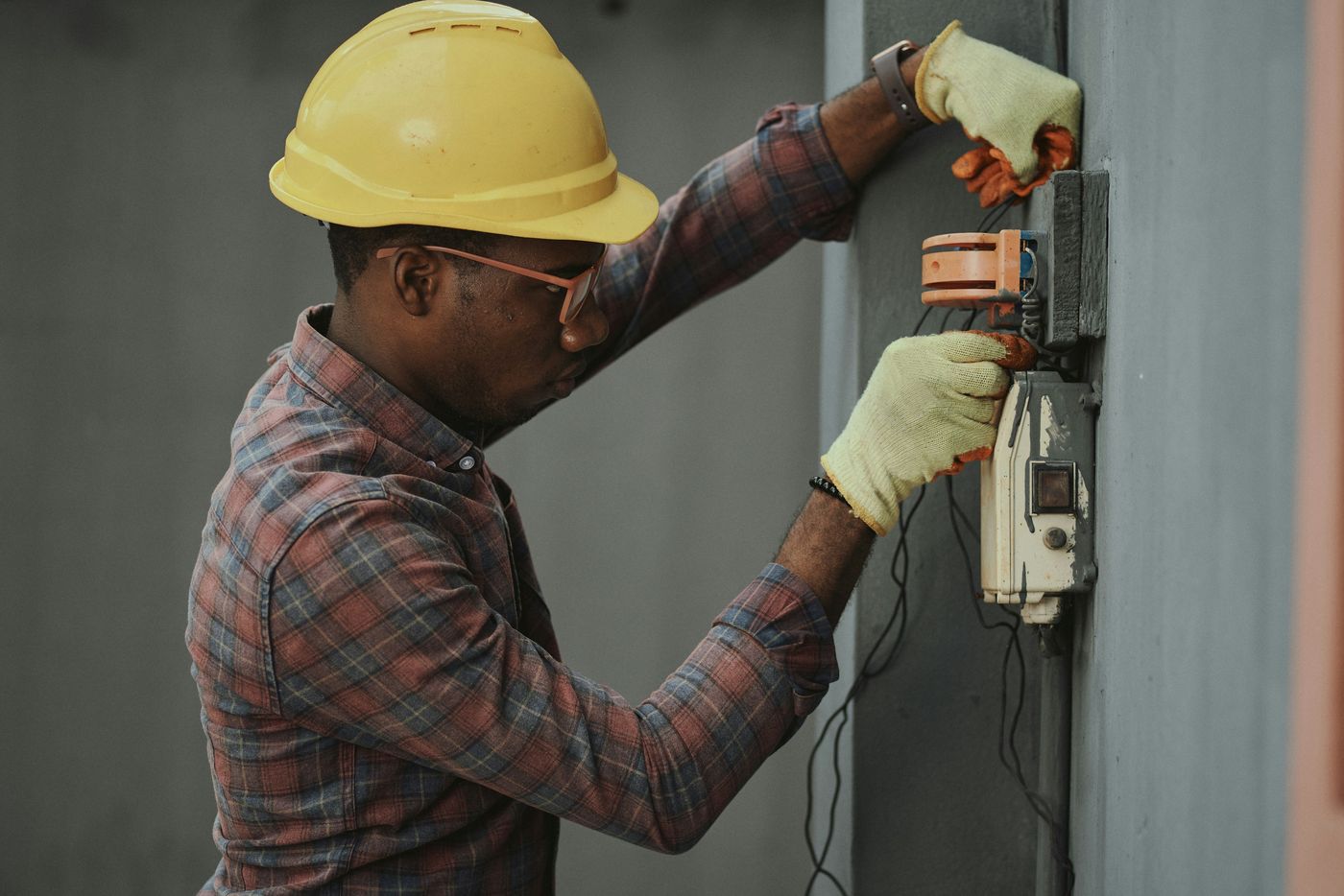 Technician inspecting an electrical distribution box