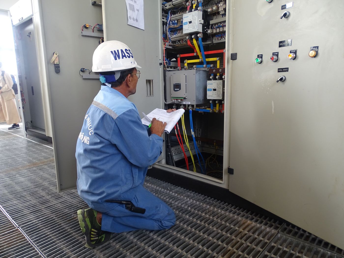Technician performing preventive electrical maintenance