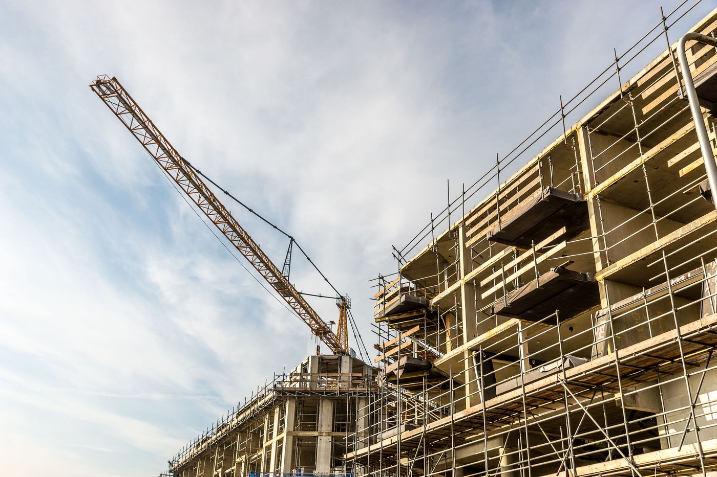 Commercial building construction site with crane